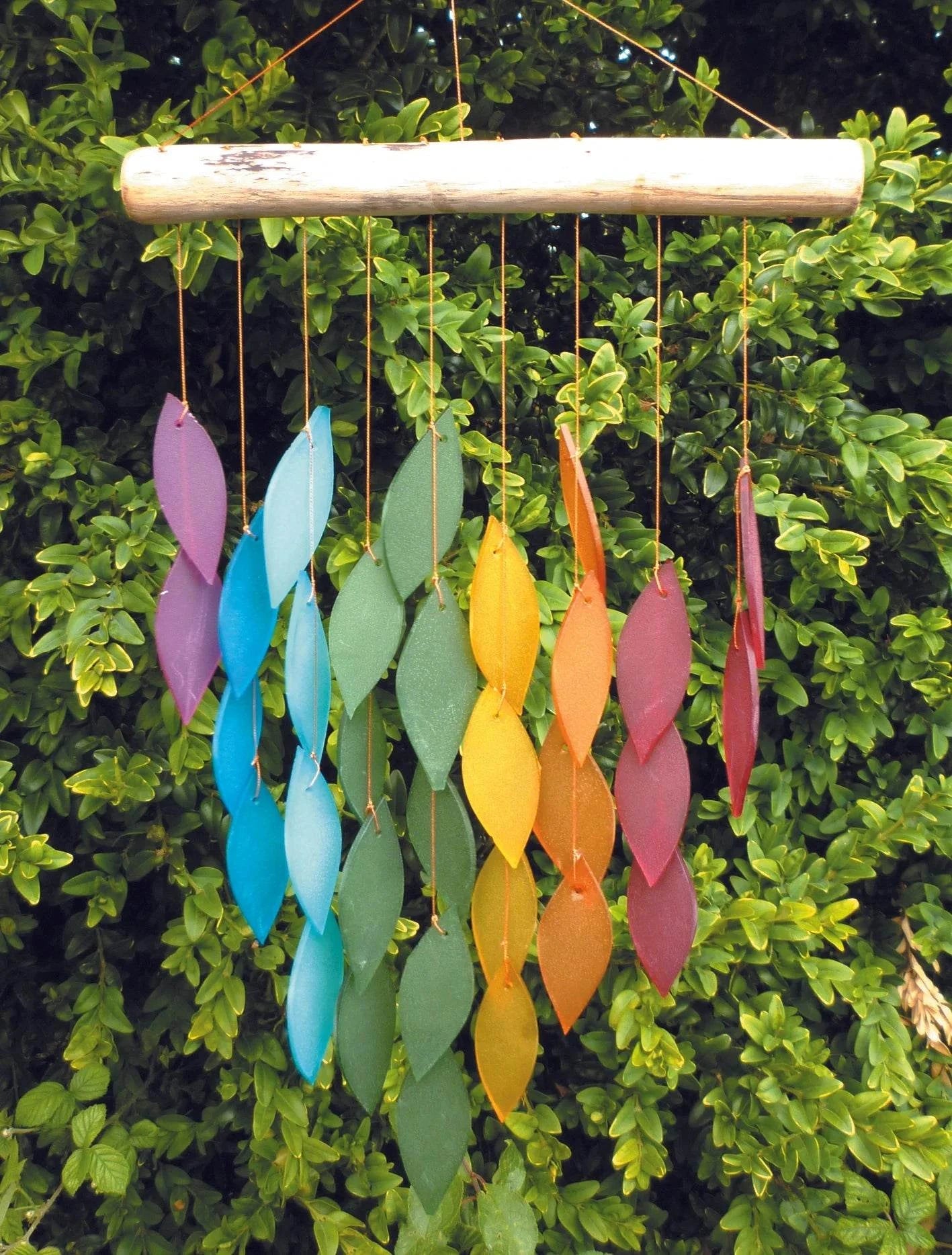 Handmade glass wind chimes with colorful recycled glass and wood, enhancing garden tranquility.