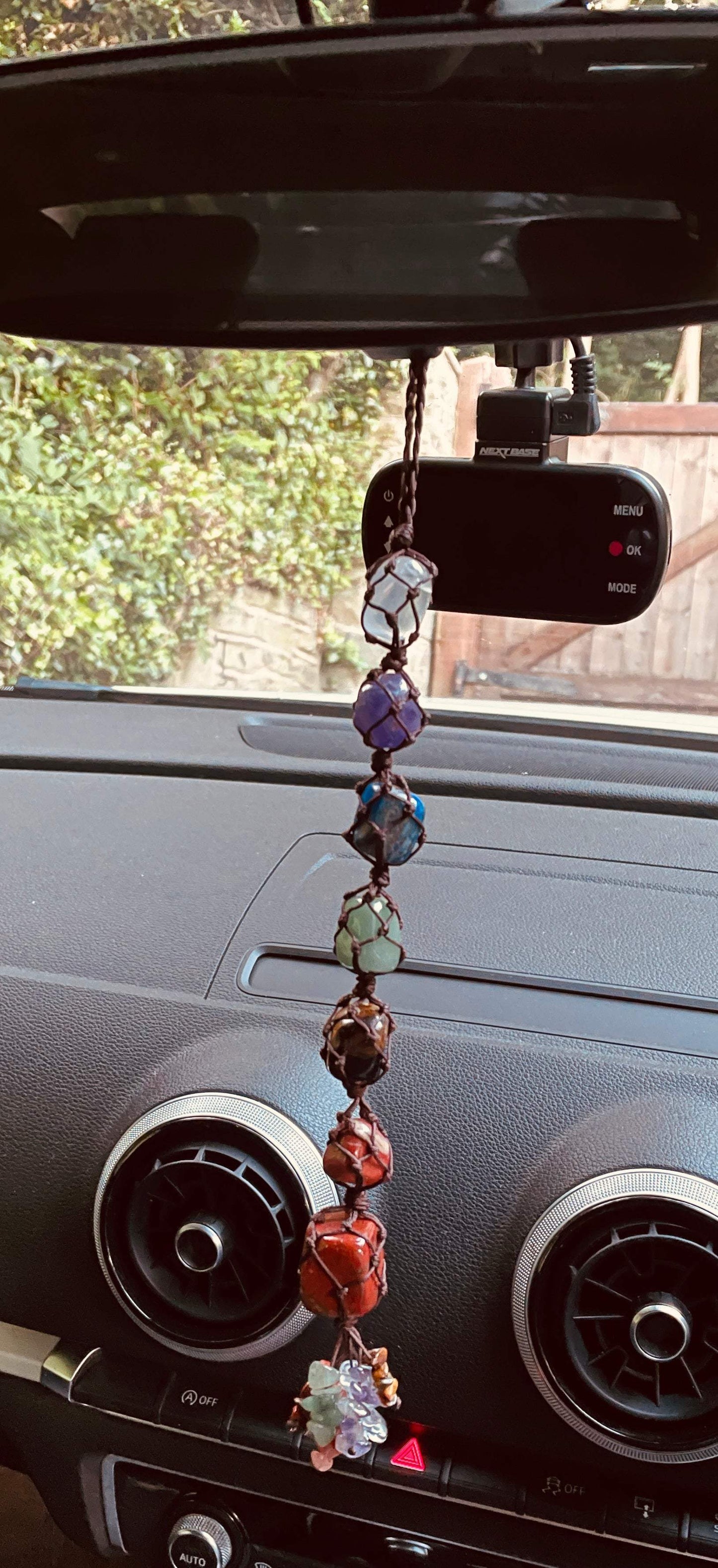Handmade 7 Chakra Healing Crystal decor hanging in car interior.