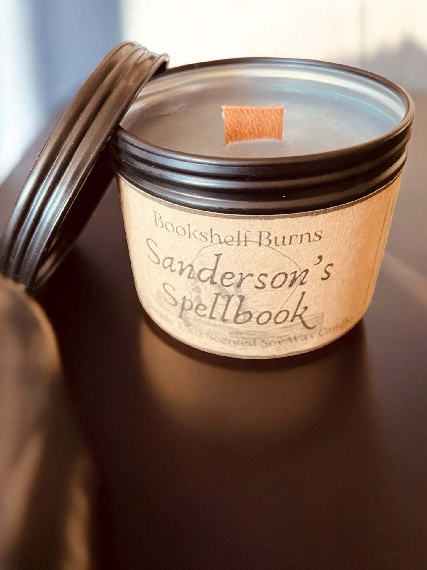 Hand poured scented candle inspired by fantasy books in a designed tin.