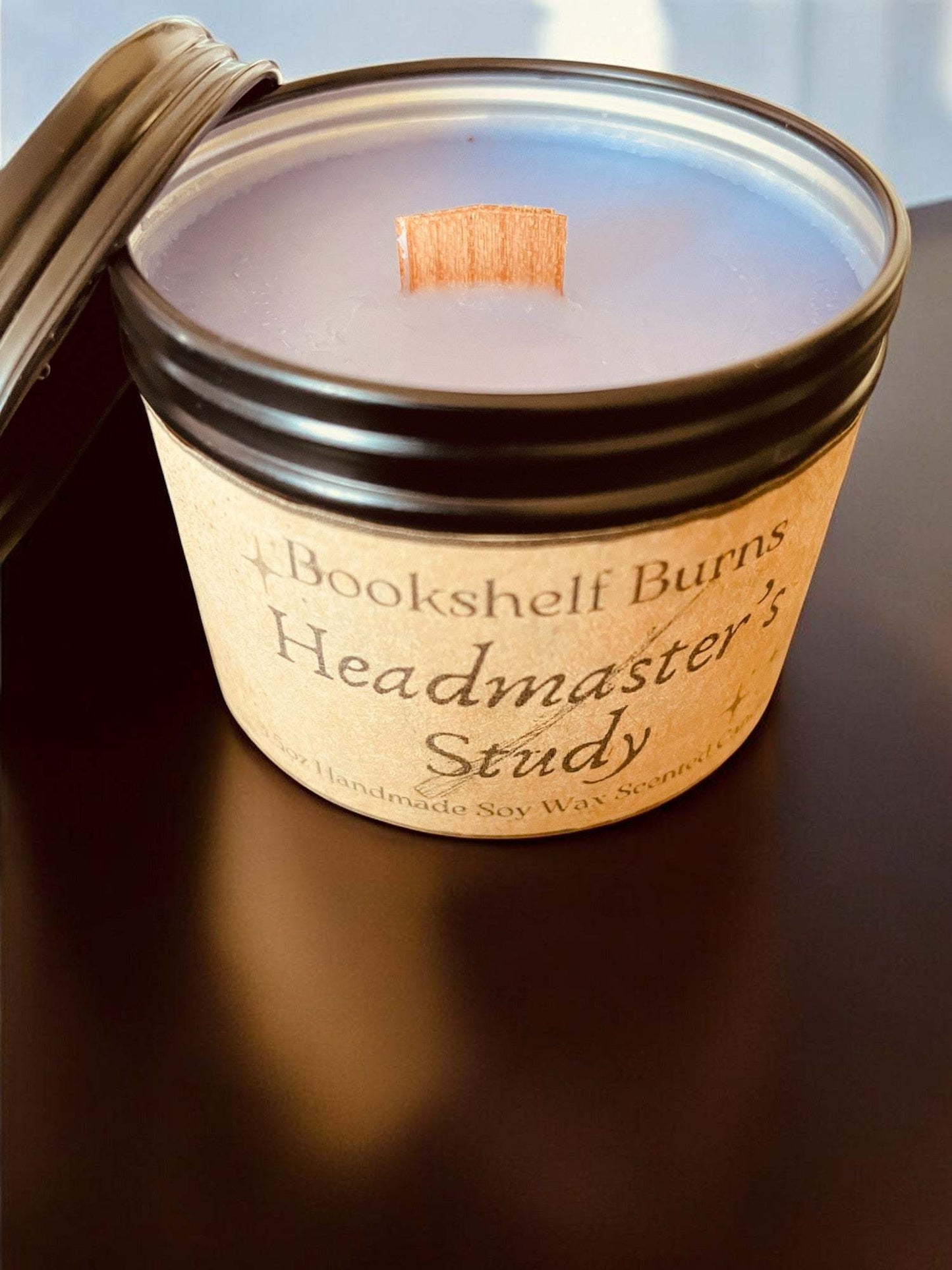 Hand-poured soy scented candle in a stylish tin labeled "Headmaster's Study," evokes literary adventures.