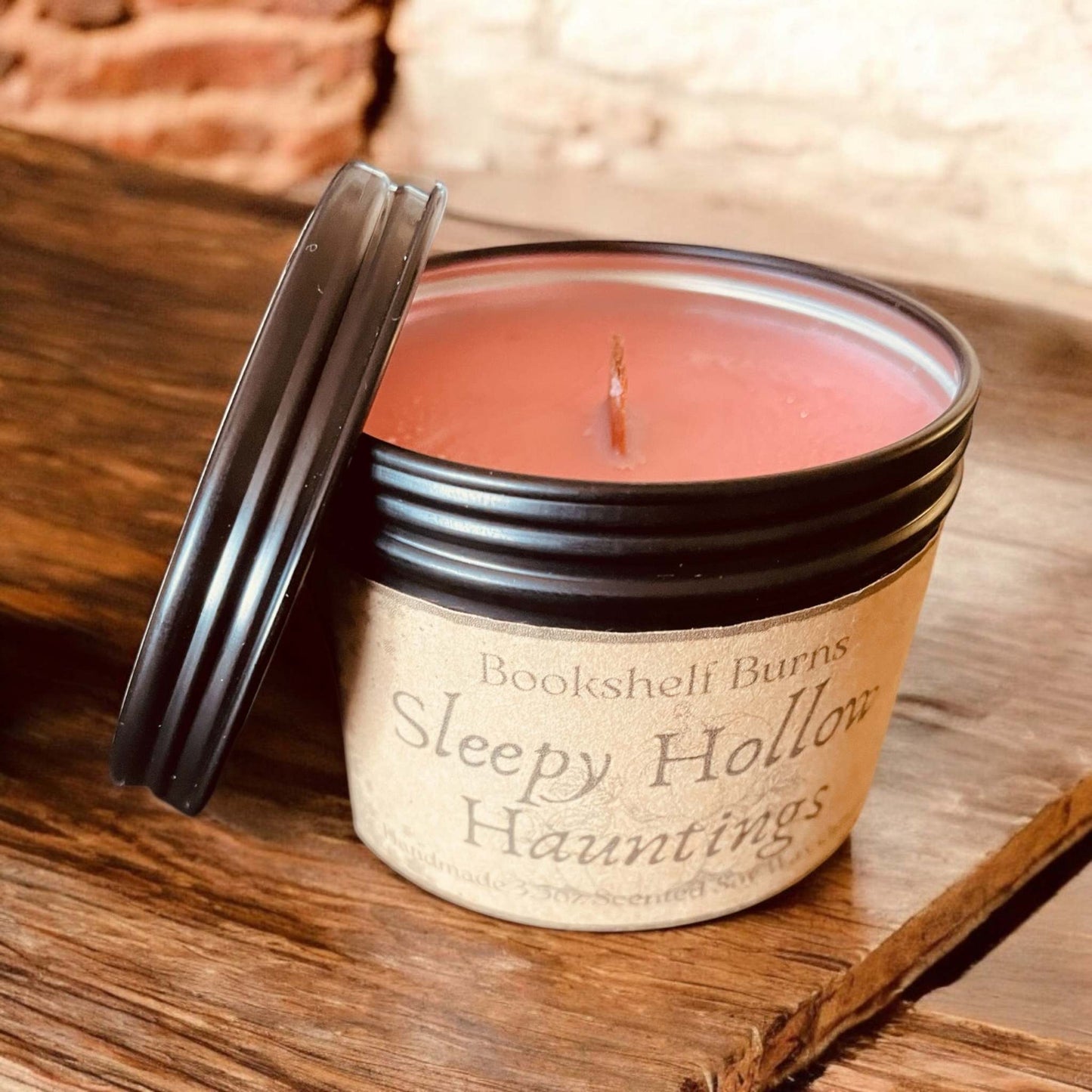 Hand poured scented candle in a tin, inspired by beloved book stories.