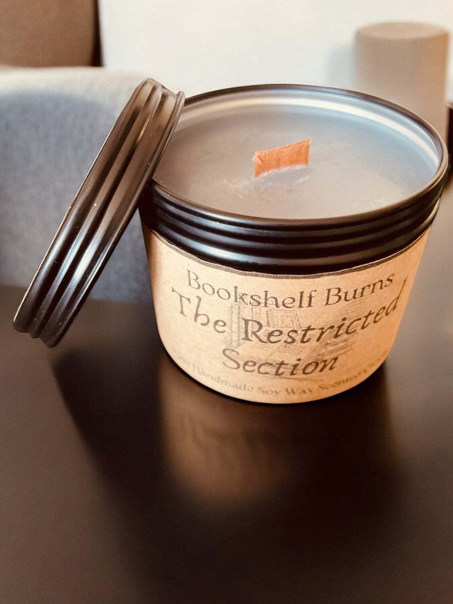 Hand poured scented candle in tin, evoking classic book themes for a relaxing atmosphere.