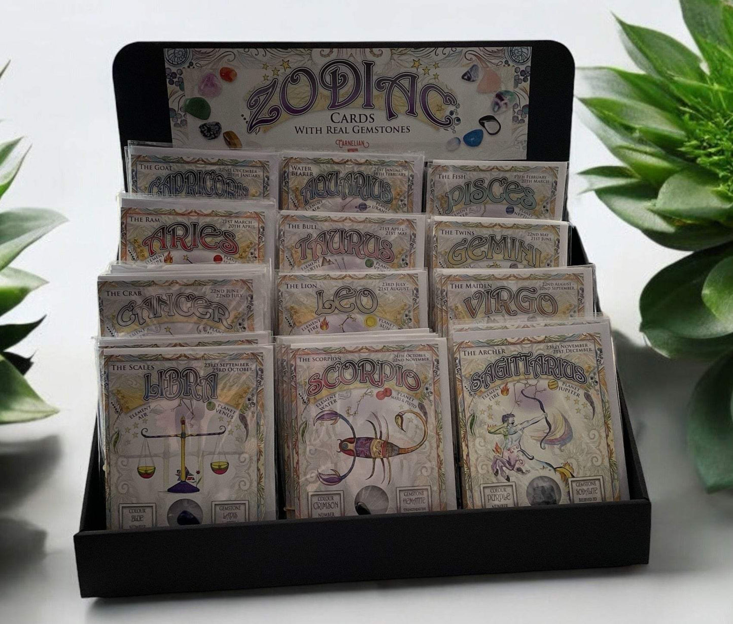 Zodiac Greeting Cards display with genuine gemstones for each sign, offering a personalized gift.
