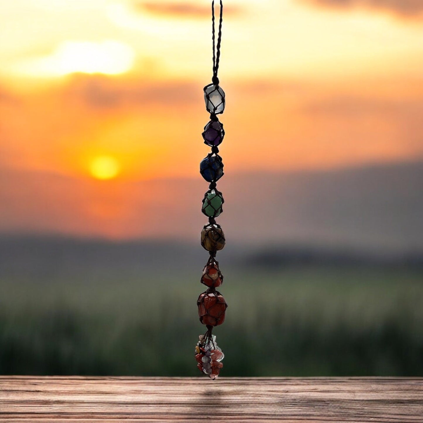 Handmade 7 Chakra Healing Crystal Window Car Decor hanging at sunset.