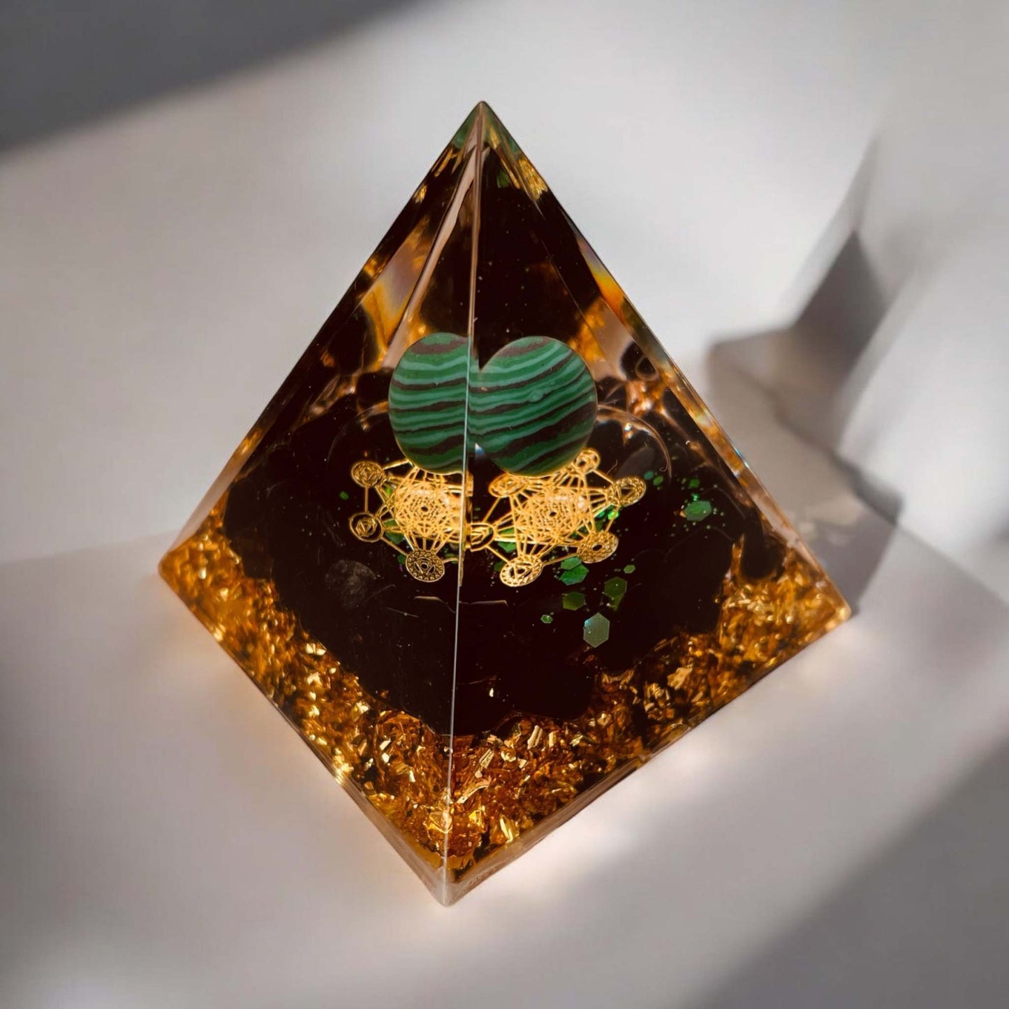Orgonite Pyramid with malachite sphere, enhancing energy and harmony, approximately 5 cm.