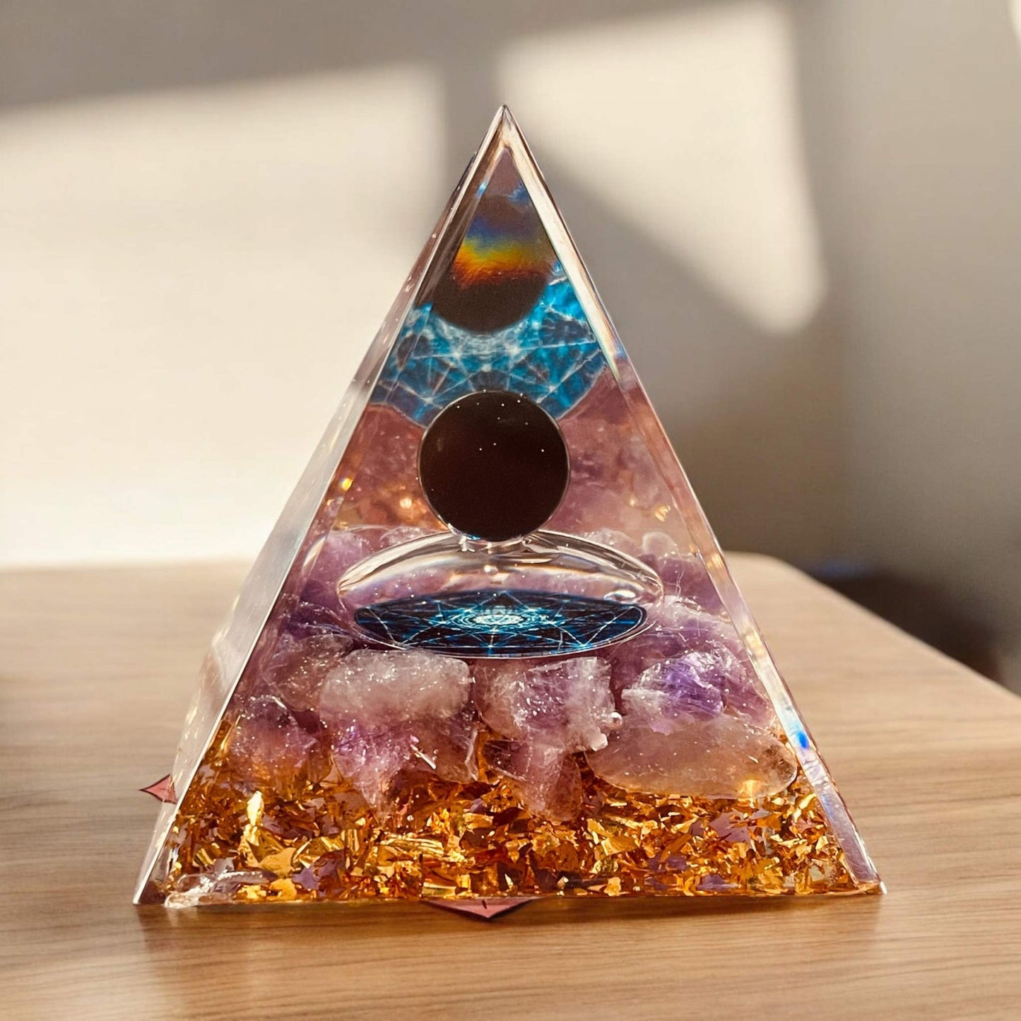 Orgonite Pyramid for energy harmonization and stress reduction, enhances room aesthetics.